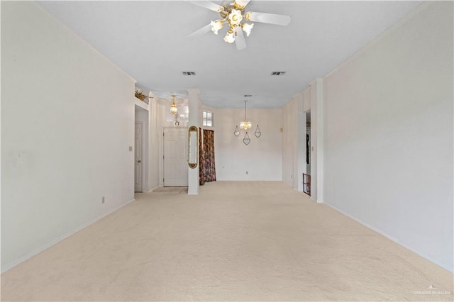 unfurnished room featuring visible vents, light colored carpet, and ceiling fan with notable chandelier