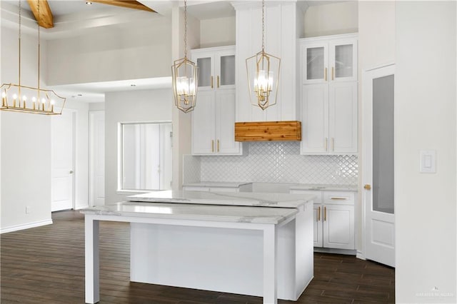 3404 Yellowhammer Ave, Mcallen, TX 78504 - kitchen featuring a chandelier, dark wood-type flooring, backsplash, white cabinetry, and beamed ceiling