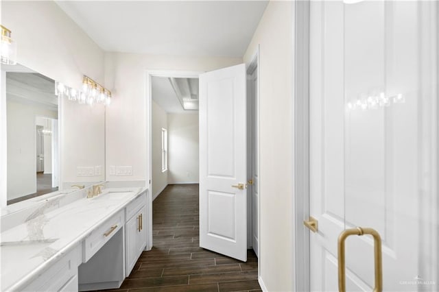 3404 Yellowhammer Ave, Mcallen, TX 78504 - bathroom featuring wood tiled floors, baseboards, and double vanity