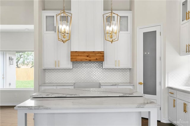 3404 Yellowhammer Ave, Mcallen, TX 78504 - kitchen featuring a chandelier, backsplash, white cabinetry, and glass insert cabinets