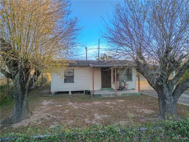 view of front of home featuring fence and a patio