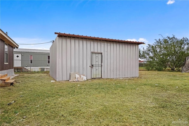 view of outbuilding with a yard