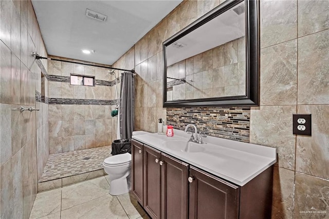 bathroom featuring a shower with curtain, vanity, tile walls, and toilet