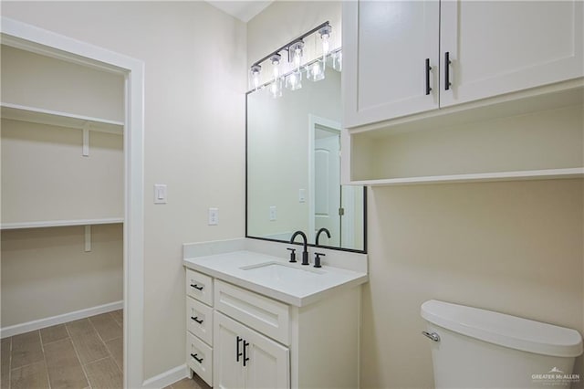 bathroom featuring hardwood / wood-style flooring, vanity, and toilet