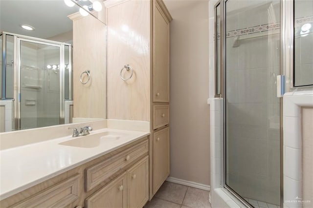 bathroom featuring tile patterned floors, vanity, and a shower with shower door