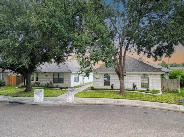 ranch-style house featuring a lawn