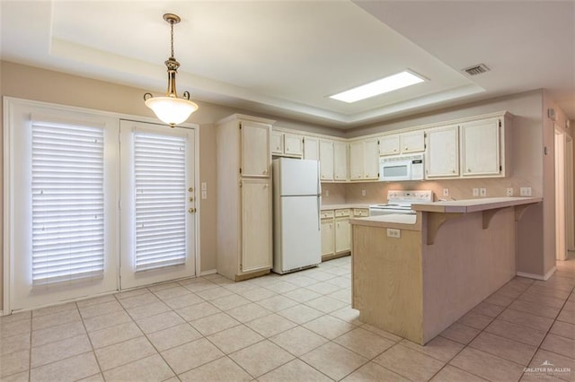 kitchen featuring white appliances, hanging light fixtures, a breakfast bar area, and light tile patterned flooring