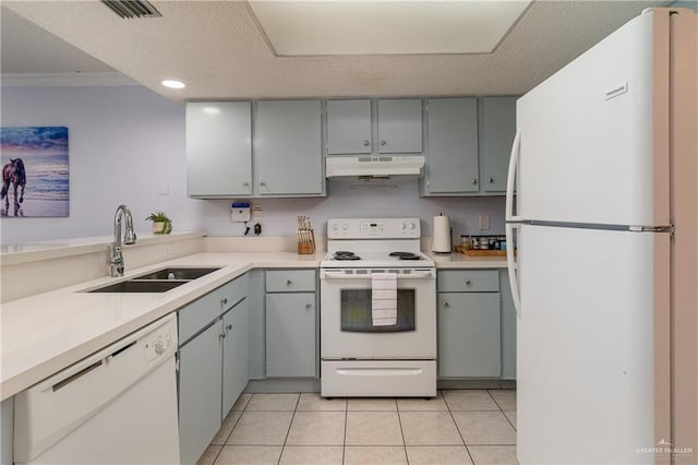 kitchen with white appliances, sink, light tile patterned floors, a textured ceiling, and ornamental molding