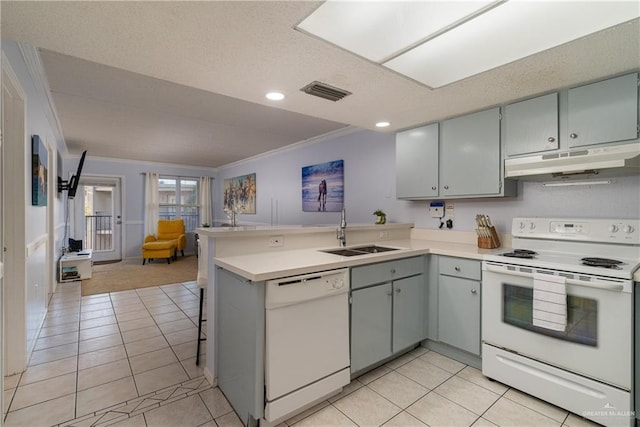 kitchen with white appliances, crown molding, sink, light tile patterned floors, and kitchen peninsula