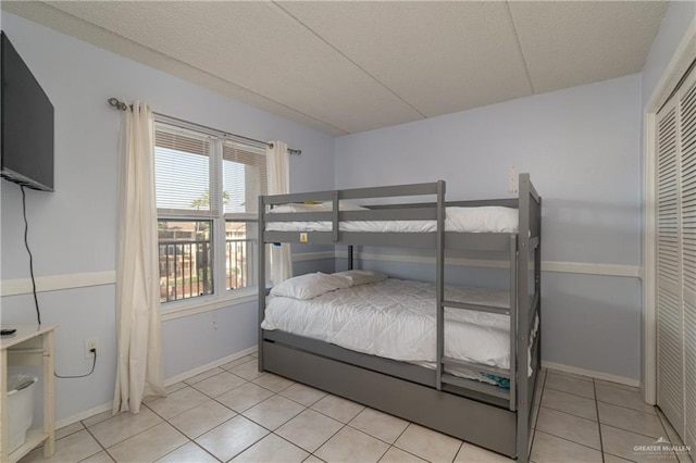 tiled bedroom with a closet