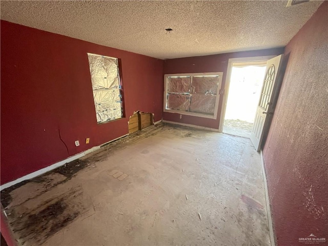 unfurnished room featuring a textured ceiling