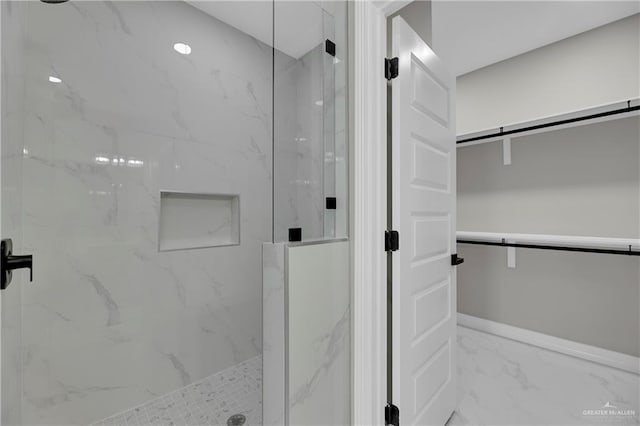 bathroom with a shower with shower door