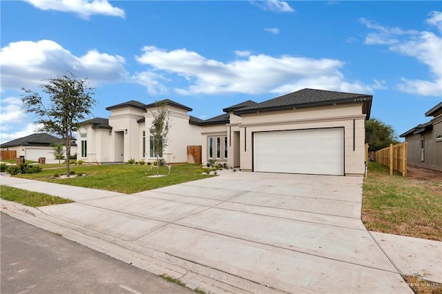 view of front of house with a garage and a front lawn