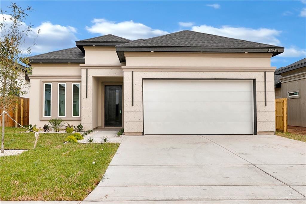 3104 N Alyna Ave, Edinburg, TX 78541 - prairie-style home with concrete driveway, stucco siding, a garage, and a shingled roof