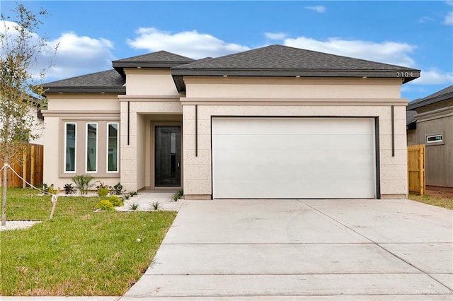 prairie-style home featuring a garage and a front yard