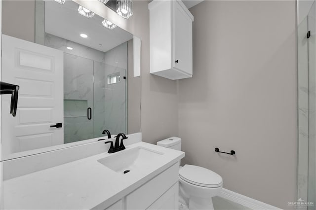 bathroom with toilet, vanity, and walk in shower