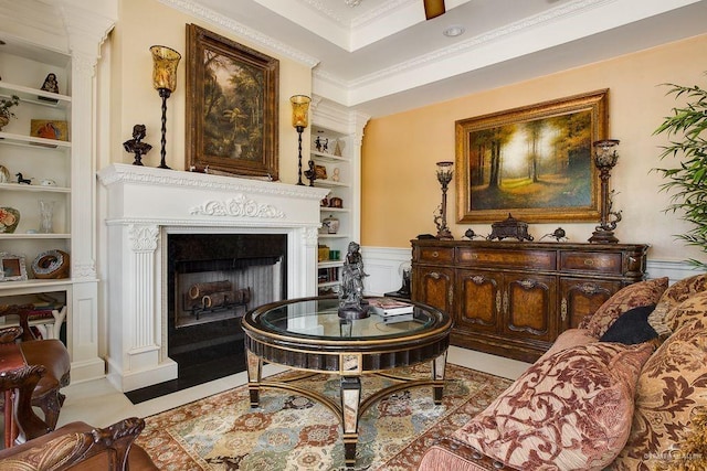 sitting room featuring built in shelves, crown molding, and light tile patterned flooring