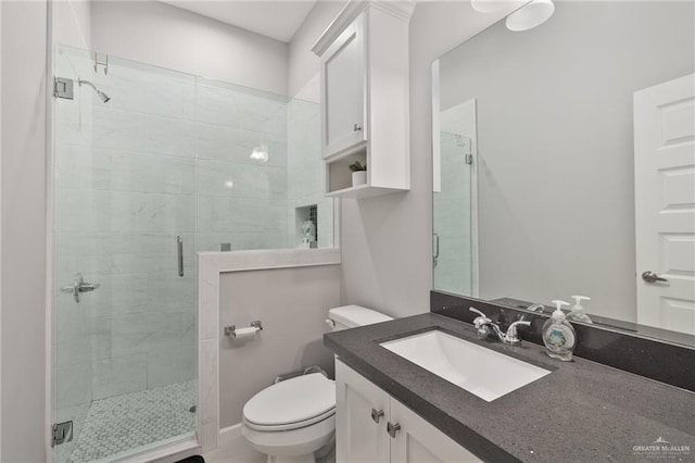 full bathroom featuring toilet, a stall shower, and vanity