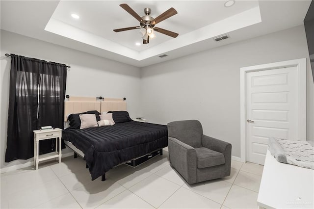 bedroom featuring a tray ceiling, visible vents, light tile patterned flooring, and recessed lighting