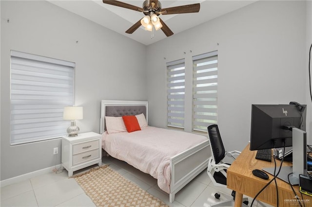 bedroom featuring baseboards, a ceiling fan, and light tile patterned flooring