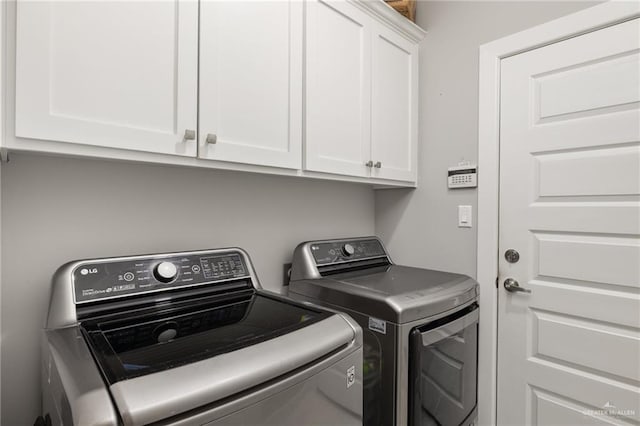 laundry room featuring cabinet space and separate washer and dryer