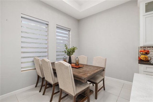 dining area featuring light tile patterned floors and baseboards