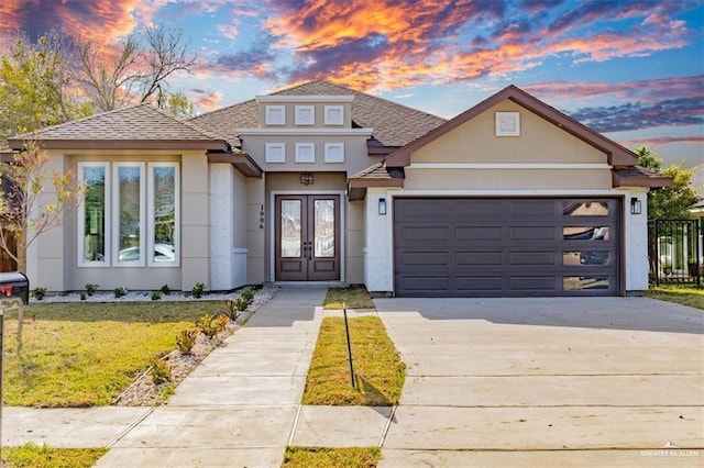 view of front of home with a yard and a garage