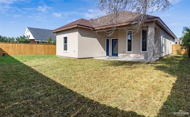 rear view of house with a yard