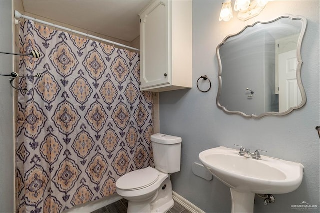1608 Merlin Dr, Mission, TX 78572 - bathroom featuring toilet and curtained shower
