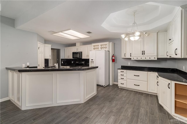 1608 Merlin Dr, Mission, TX 78572 - kitchen featuring black microwave, white refrigerator with ice dispenser, range, and dark wood-style flooring