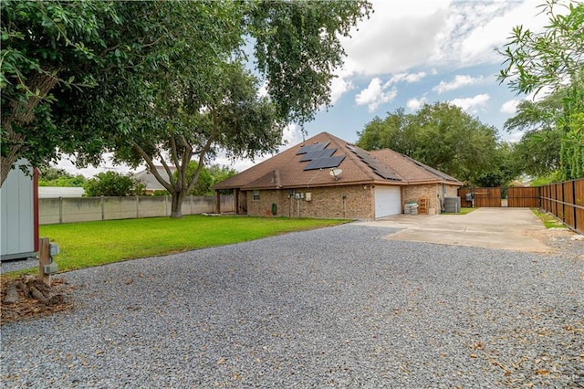 1608 Merlin Dr, Mission, TX 78572 - view of side of property with roof mounted solar panels, concrete driveway, a garage, and brick siding