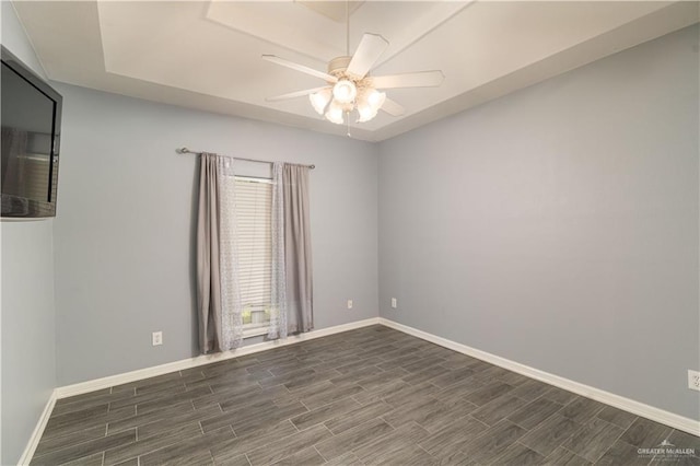 1608 Merlin Dr, Mission, TX 78572 - spare room featuring dark wood finished floors, a ceiling fan, and baseboards