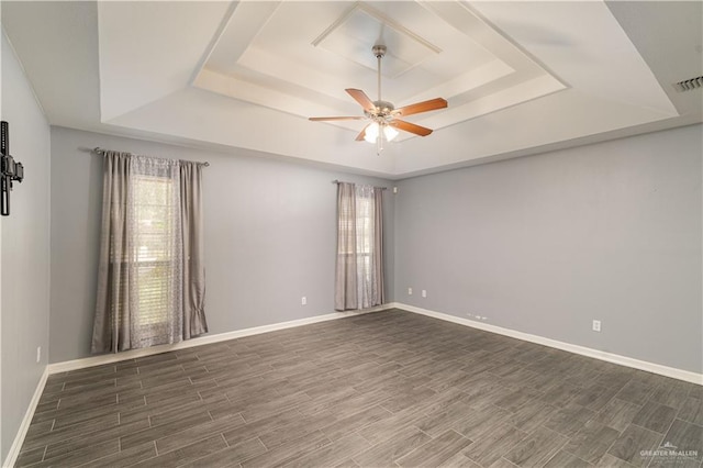 1608 Merlin Dr, Mission, TX 78572 - spare room featuring a raised ceiling, plenty of natural light, ceiling fan, and wood finished floors