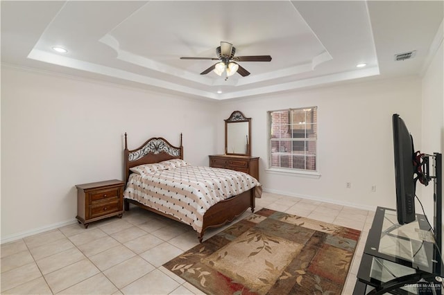 bedroom featuring ceiling fan, light tile patterned floors, and a tray ceiling