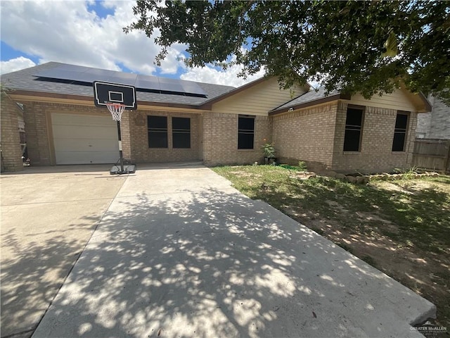 3020 Nickel Ave, Mission, TX 78574 - single story home featuring brick siding, roof mounted solar panels, concrete driveway, and a garage