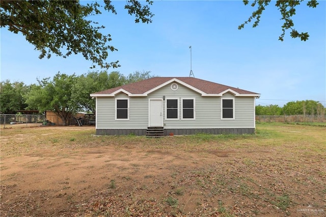 manufactured / mobile home with fence, a front yard, and entry steps