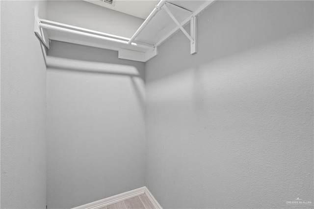 spacious closet with wood finished floors