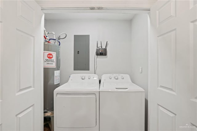 clothes washing area featuring washing machine and clothes dryer, water heater, laundry area, and electric panel