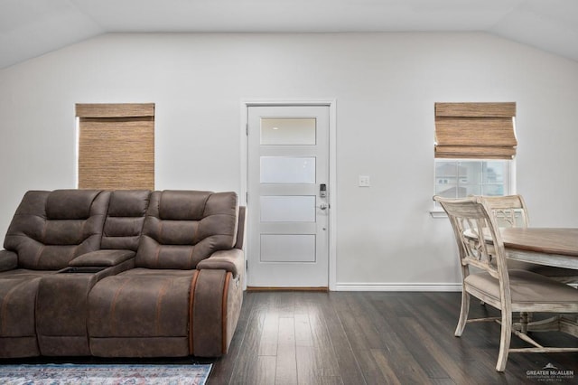 living room featuring vaulted ceiling and dark hardwood / wood-style flooring