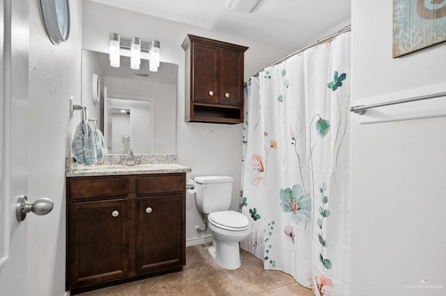 bathroom featuring vanity, curtained shower, and toilet