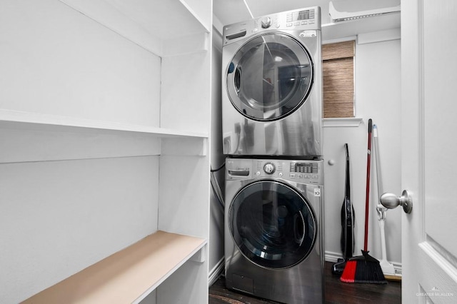 washroom with dark wood-type flooring and stacked washer / drying machine