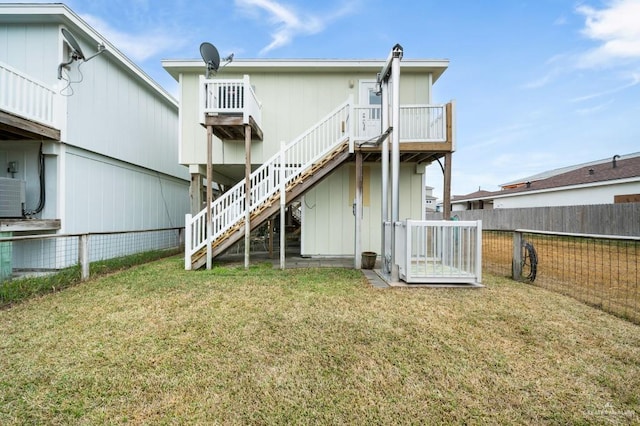 rear view of property with a lawn