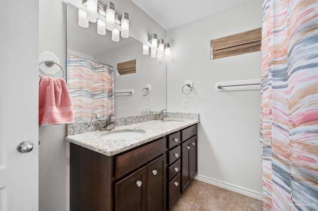 bathroom with vanity, curtained shower, and tile patterned flooring