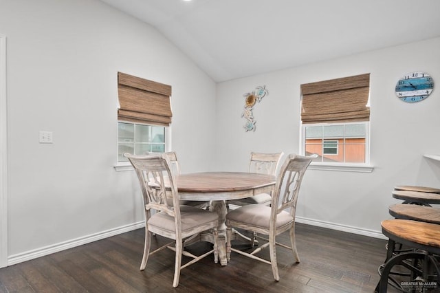 dining area featuring lofted ceiling and dark wood-type flooring