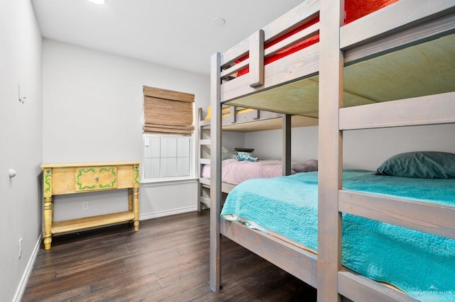 bedroom with dark wood-type flooring