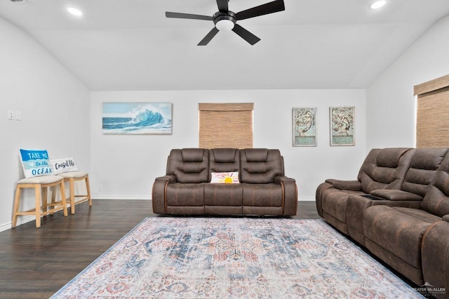 living room with ceiling fan, dark hardwood / wood-style floors, and vaulted ceiling