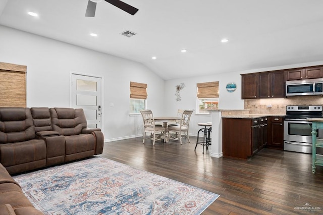 living room featuring ceiling fan, lofted ceiling, and dark hardwood / wood-style flooring