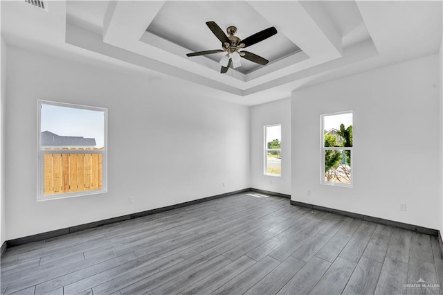 2820 Linva Ave, Mcallen, TX 78541 - unfurnished room with wood finished floors, ceiling fan, a tray ceiling, and baseboards
