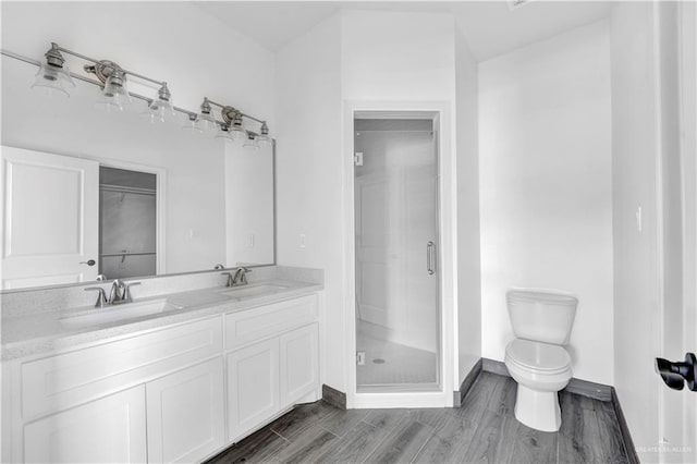 2820 Linva Ave, Mcallen, TX 78541 - bathroom featuring toilet, a sink, a shower stall, and baseboards