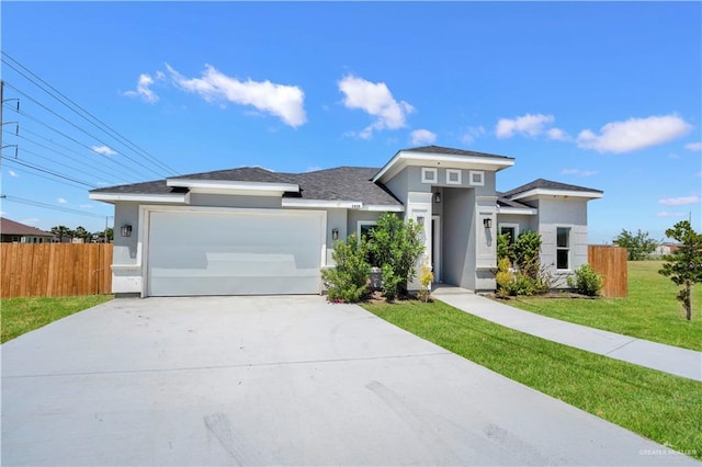 2820 Linva Ave, Mcallen, TX 78541 - prairie-style house with stucco siding, fence, a front yard, concrete driveway, and an attached garage